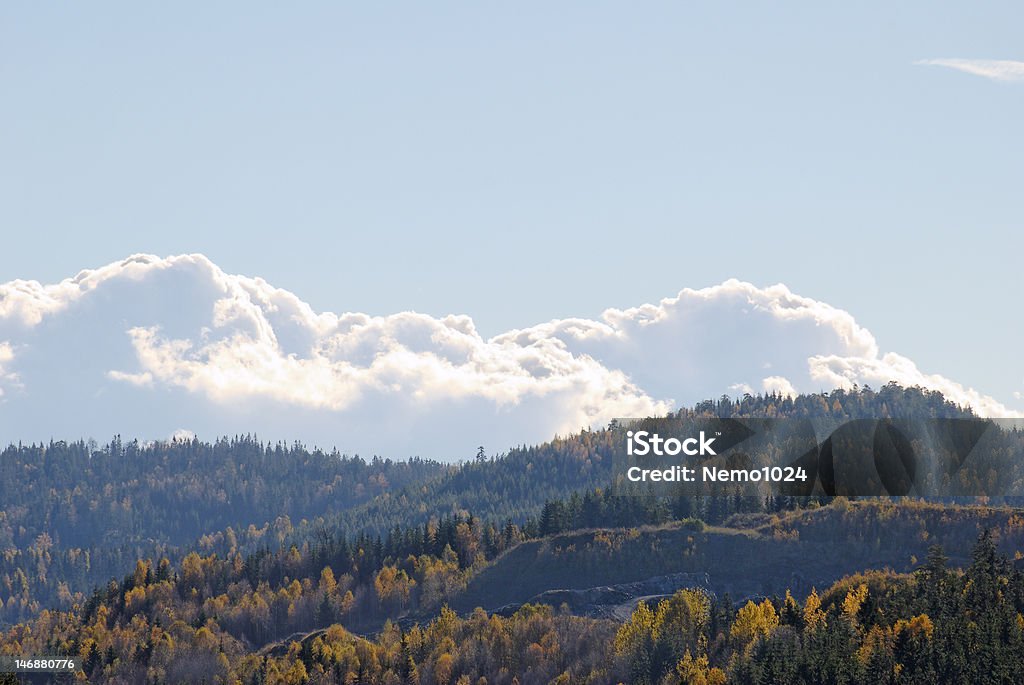 Clouds over Mountains Billowing clouds over mountains clad in autumn-coloured forests Autumn Stock Photo