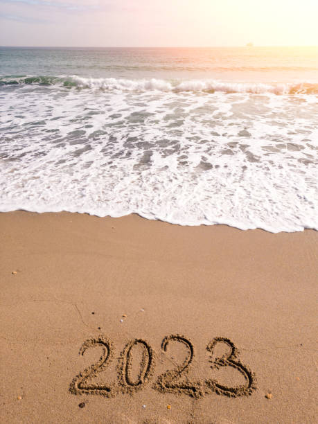 istock 2023 year written on sandy beach sea at sunny day 1468810714