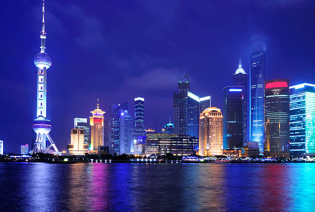 istock Shanghai skyline reflecting into the water at night 146881090