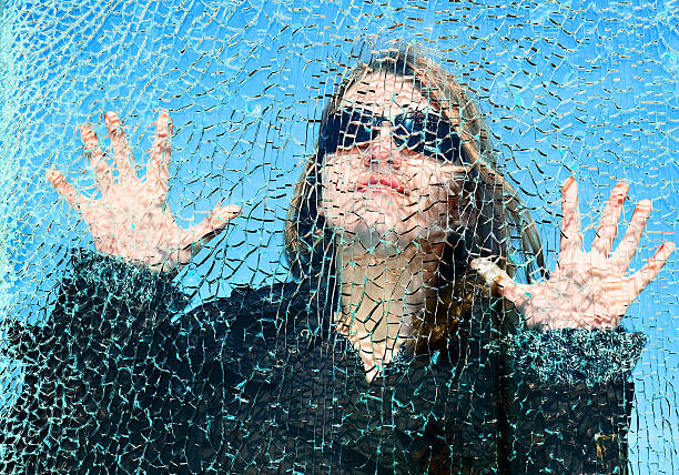 broken dreams - broken window glass women fotografías e imágenes de stock