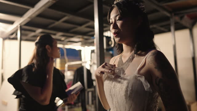 Nervous Asian chinese female opera singer deep breath before solo performance at backstage waiting