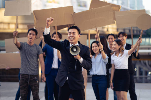 istock Group of activists with banners protesting to democracy and equality. Men and women doing a silent protest for democracy and equality 1468819464