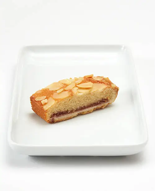 Golden sponge cake with raspberry flavoured jam topped with almond flakes.