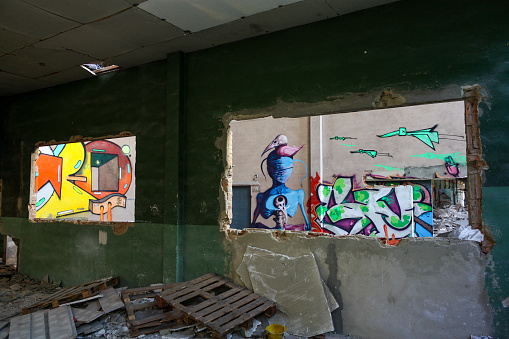 San Claudio, Spain; December 11th 2015: graffiti art through empty windows in San Claudio abandoned pottery factory