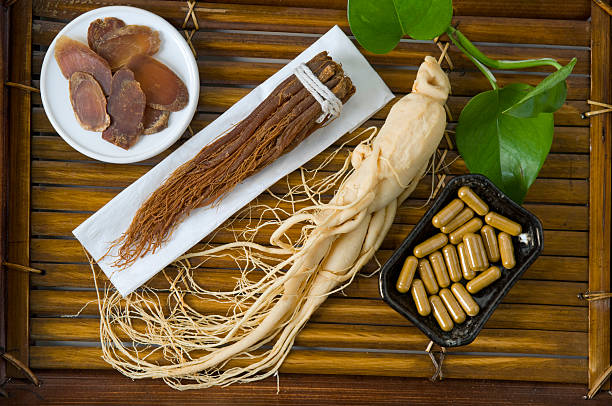 Dry Ginseng Slices, capsules and roots stock photo