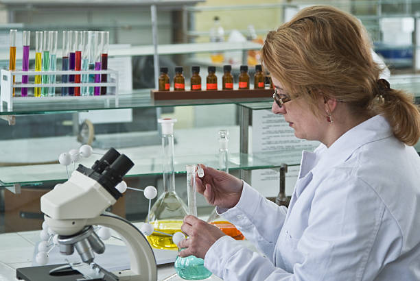 Female lab researcher or scientist Female researcher opening a glass recipient in the chemistry laboratory. chemical worker stock pictures, royalty-free photos & images