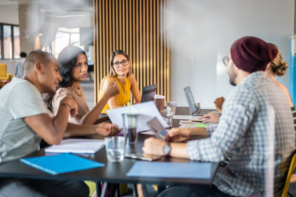 istock Businesswoman talking with colleagues 1468828985