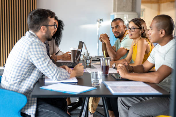 istock Businessman talking with colleagues 1468829181