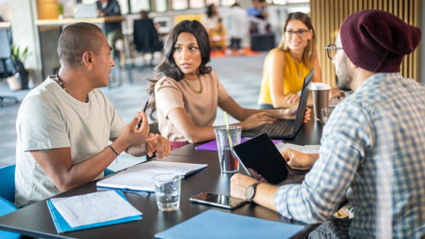 istock Businessman talking with colleagues 1468829182