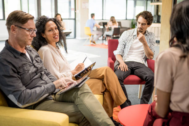 istock Businesswoman talking with colleagues 1468829206