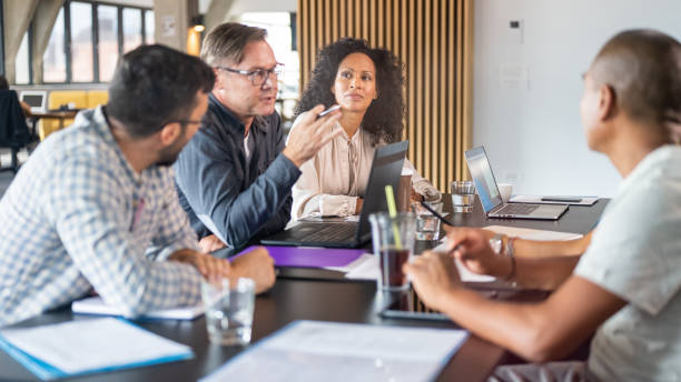 istock Businessman talking with colleagues 1468829223