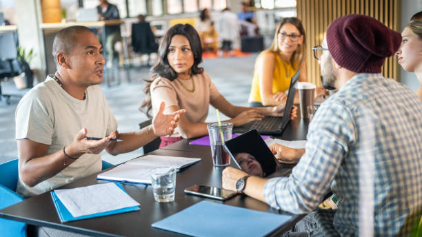 istock Businessman talking with colleagues 1468829268