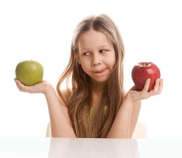 istock Little girl and two apples 146882966