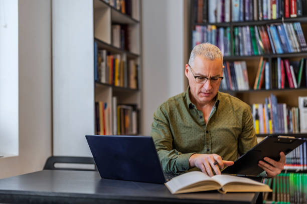 istock Bookstore owner with clipboard taking inventory 1468830533