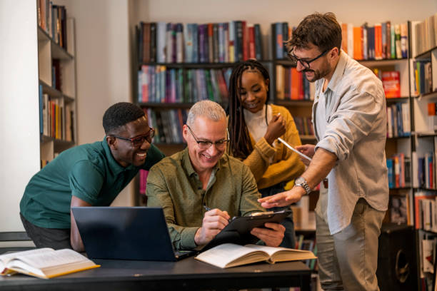 istock Happy mature professor and his students at campus 1468830618
