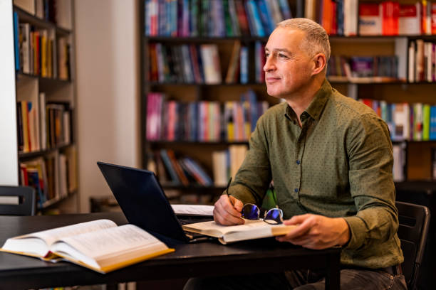istock Mature male writer in office looking away. 1468830863