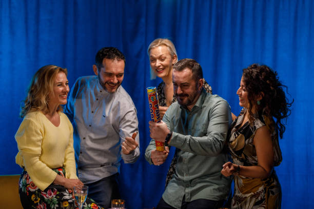 istock Cheerful man setting off a confetti popper during a party 1468831892
