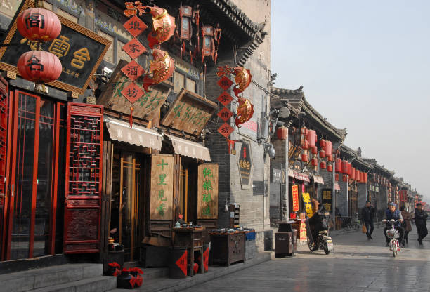 Pingyao in Shanxi Province, China.: A main street in Pingyao with a hotel, shops and stores