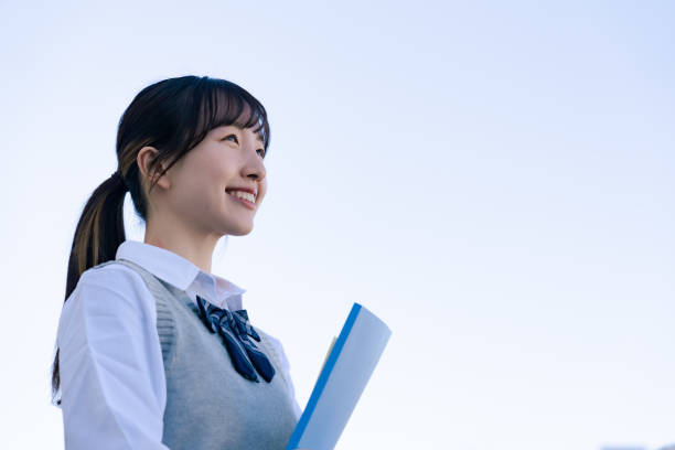 istock A high school girl in uniform looking far outside 1468839826