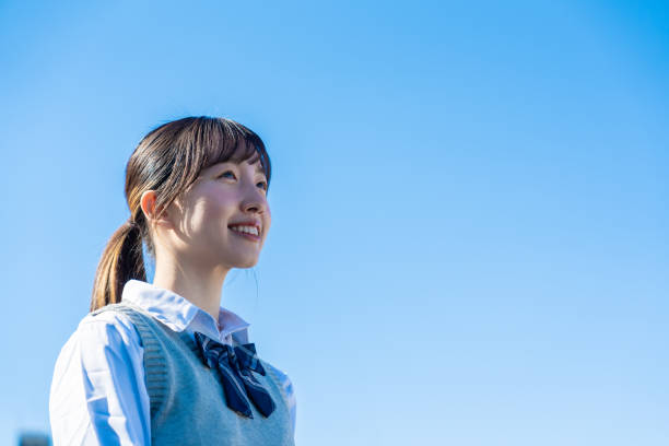 istock A high school girl in uniform looking far outside 1468839883