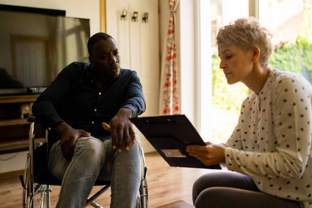 istock A man in a wheelchair with social worker 1468841453
