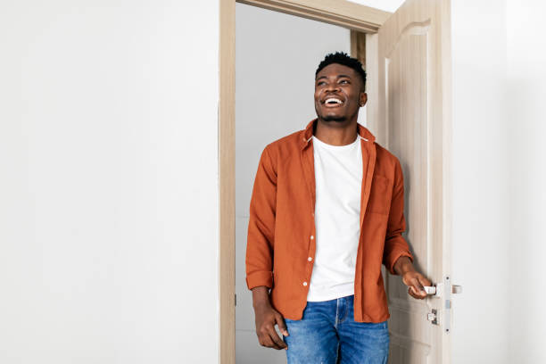 istock Cheerful Black Guy Entering New Home Opening The Door 1468842902