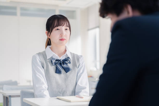 istock High school girls interviewing a teacher 1468843701