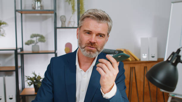 istock Mature business man working, having mobile phone talk at office workplace using messenger chat apps 1468844000