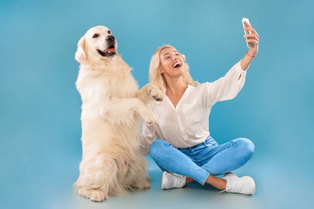 istock Young woman taking selfie with her dog 1468844126