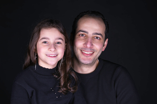 Eight-year-old girl photographed with her father.