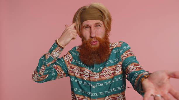 istock Hippie redhead man pointing at camera and showing stupid gesture, blaming some idiot for insane plan 1468844575