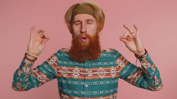 istock Hippie man breathes deeply with mudra gesture, eyes closed, meditating, relaxing, keep calm down 1468844583