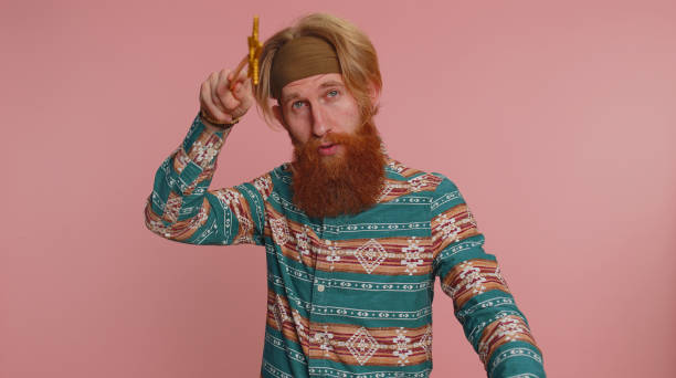 Magician wizard hippie man gesturing with magic wand making wish come true, casting magician spell