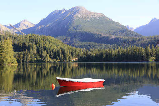 red boat on mountain lake Strebske Pleso in Slovakia