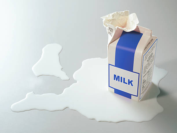 milk carton carton of milk opened with spilt milk around it milk carton stock pictures, royalty-free photos & images