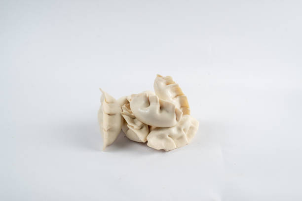 Frozen semi-finished dumplings on a white background. Dumplings isolated