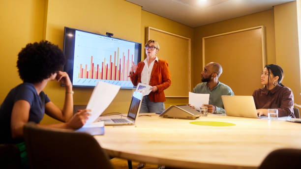 istock Manager discussing graphs with her business team during a board room meeting 1468855164