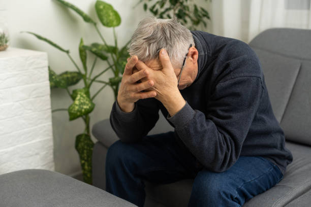 istock Tired old man suffering from headache, massaging his temples. Strong migraine attack. An elderly man has a headache, massaging his temples 1468856634