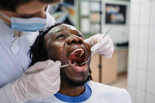 istock Young Man Having A Dental Treatment At The Dentist's Office 1468856945
