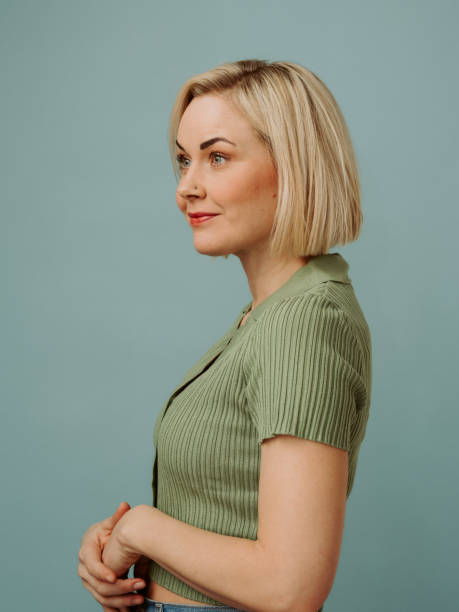 Simple portrait of mid adult woman in her 40s with a short blonde bob in casual clothing stock photo