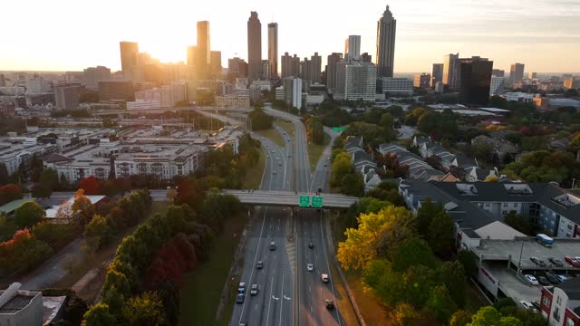 Cinematic aerial Atlanta Georgia skyline. Warm golden hour light in autumn with Atlanta GA housing and skyscrapers. Cityscape view.