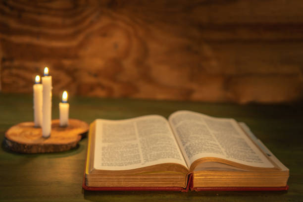 istock Selective focus of a bible with candles on a wooden background with copy pace 1468859345