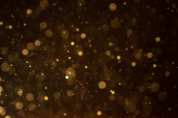 istock Organic bokeh dust particles floating on light beam on black background. Glittering sparkling 1468860392