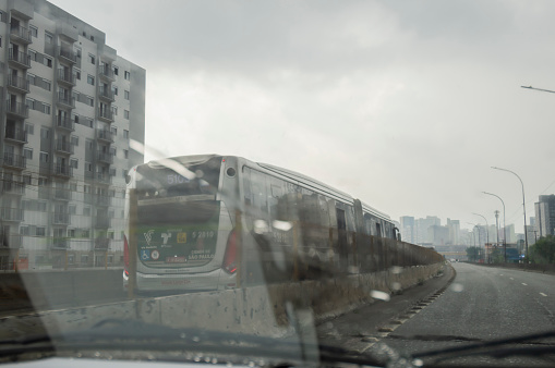 Saõ paulo-sp,brasil-february 22,2023 bus passing on brt on a rainy day,view from inside a car.