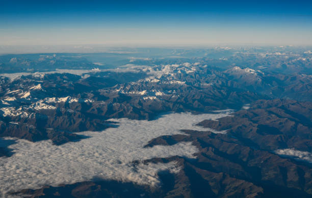 istock Aerial view above the clouds at mountain peaks 1468862596