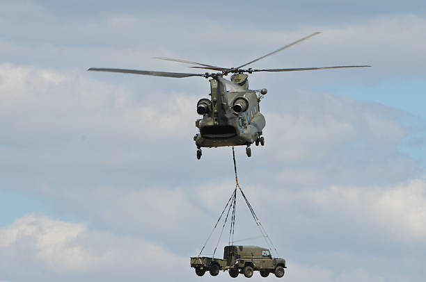 istock Chinook Helicopter transporting Car 146886475