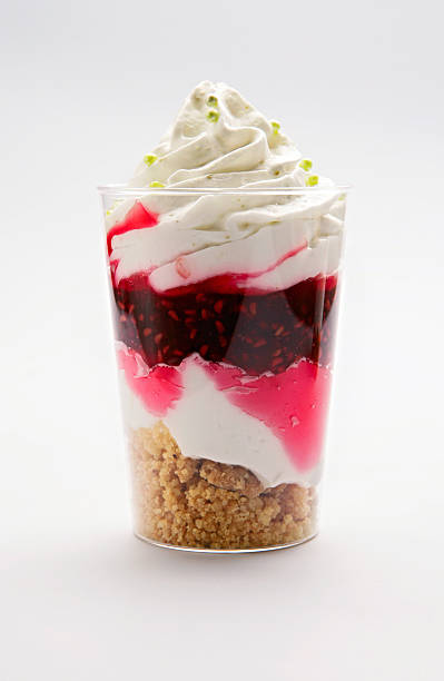 Mousse with lime, raspberry and crumble stock photo
