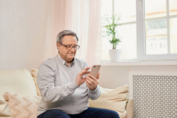 istock Portrait of smiling mature man using mobile phone 1468866163