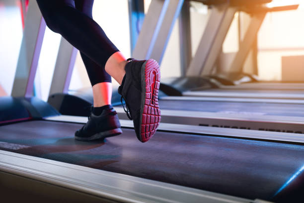 one woman running on a tread mill close up shot to the feet. - run of the mill imagens e fotografias de stock