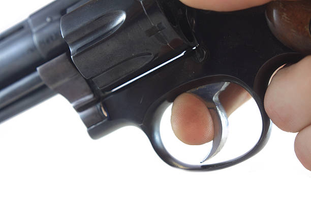 hand gun with finger on trigger stock photo